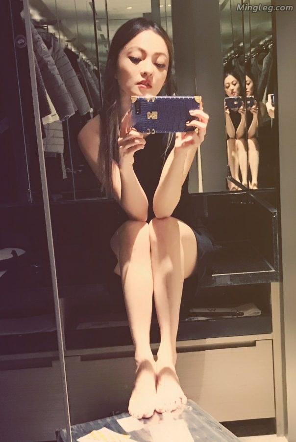 Angela Chang took a selfie with her mobile phone with bare feet(1/2)