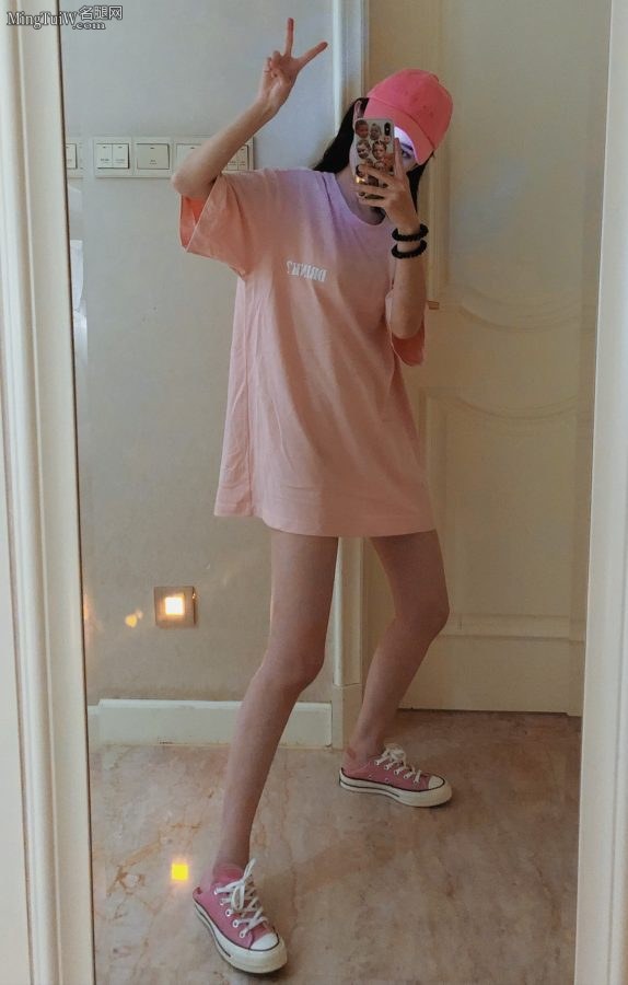 Beautiful girl Hanikezi in pink skirt takes a selfie with thin legs in front of the mirror(1/2)
