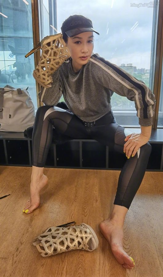 Liti Chung took off her high heels to reveal her big feet painted with yellow nail polish(3/6)