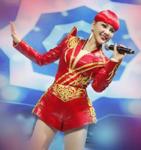 内蒙古女歌手乌兰图雅一身喜庆红色装扮，美腿穿高跟皮靴演出