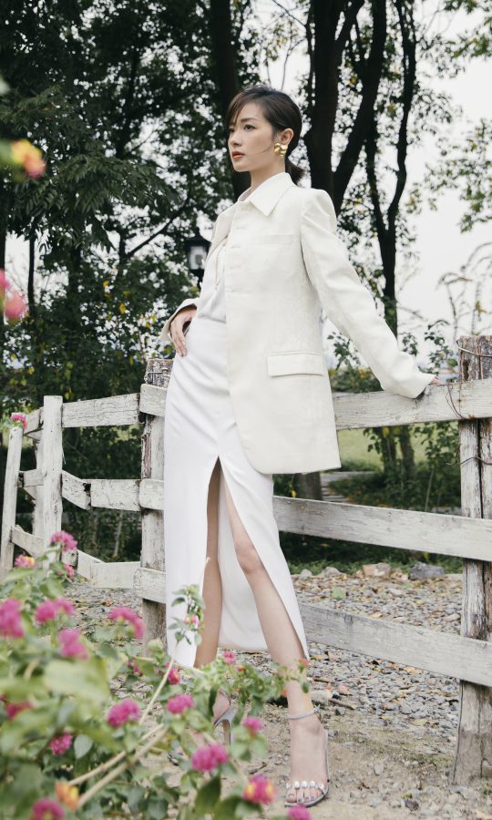 女星万茜穿开叉白裙踩Sergio Rossi高跟在花园拍摄美照(1/3)