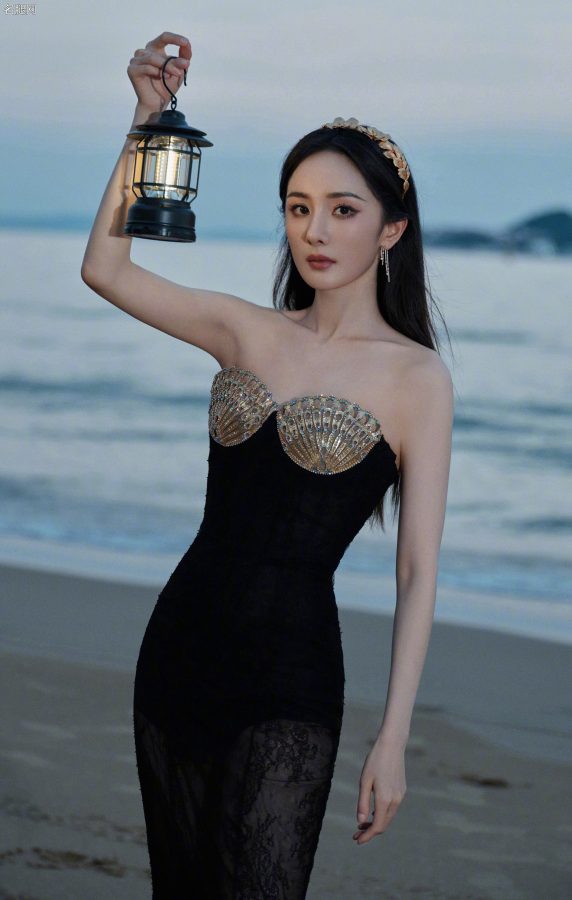 杨幂穿扇贝护胸礼服薄纱裙摆透美腿站在海滩上(7/13)